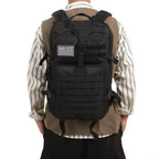 Black tactical backpack with MOLLE webbing front panel and adjustable shoulder straps