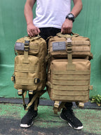 Tactical MOLLE rucksack pair in tan with front flap pockets, webbing straps, U.S. flag patches
