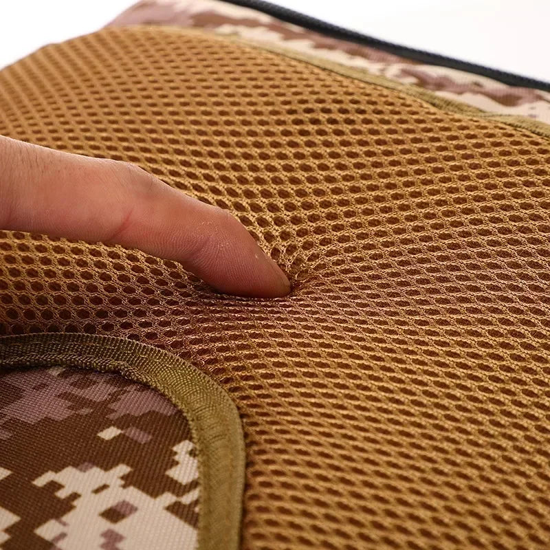 Tactical backpack mesh-padded strap and desert camo seam detail.