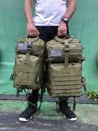 Tactical MOLLE rucksack pair in olive tan camouflage with front flap pockets and U.S. flag patches