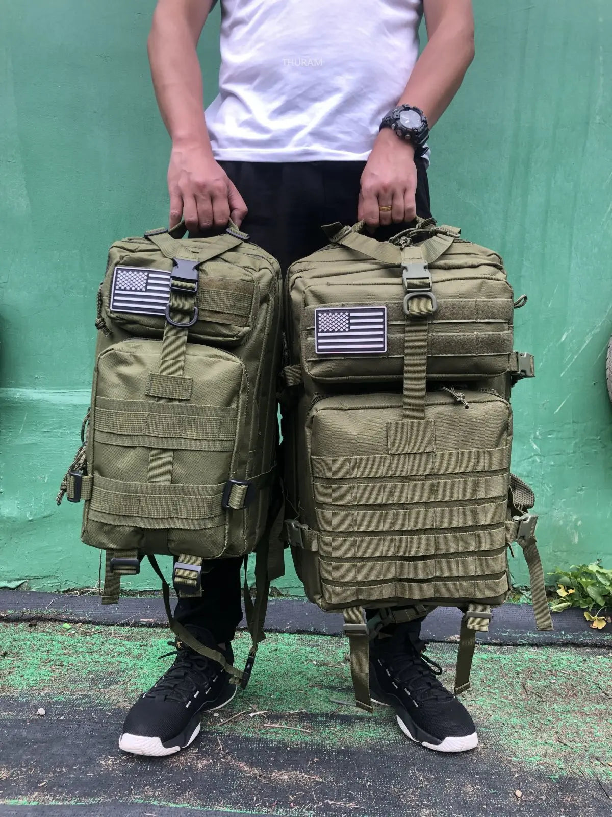 Tactical MOLLE rucksack pair in olive tan camouflage with front flap pockets and U.S. flag patches