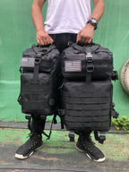 Tactical MOLLE rucksack pair in black with front flap pockets, MOLLE webbing and U.S. flag patches