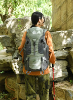 Outdoor hiking backpack in gray and tan with front zip pocket and side straps