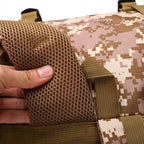 Tactical backpack shoulder strap with mesh padding and desert camo fabric.