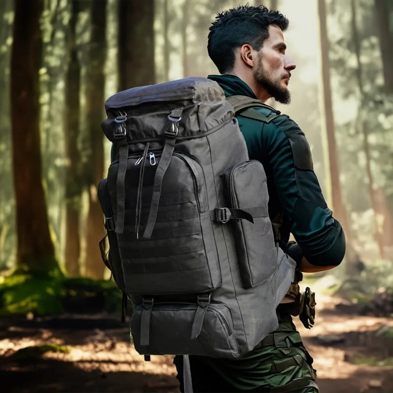 Dark gray tactical backpack with front pockets, side pouches, and adjustable shoulder straps
