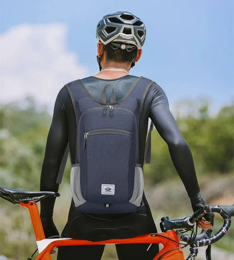Person wearing a blue backpack and cycling helmet with a bicycle outdoors.