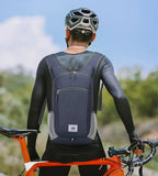 Person wearing a blue backpack and cycling helmet with a bicycle outdoors.