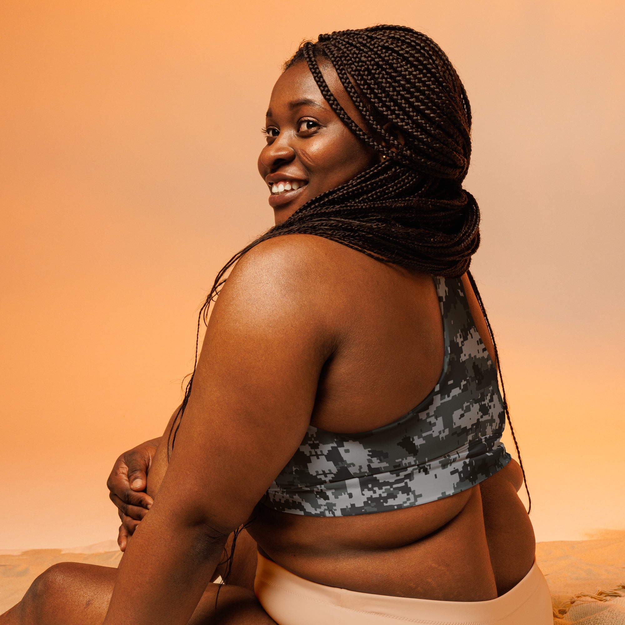 Longline sports bra in dark digital camo, racerback back view and wide hem