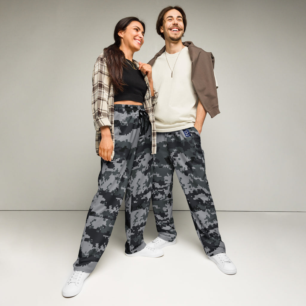 Wide-leg digital camo joggers on models, showing relaxed fit and elastic waistband