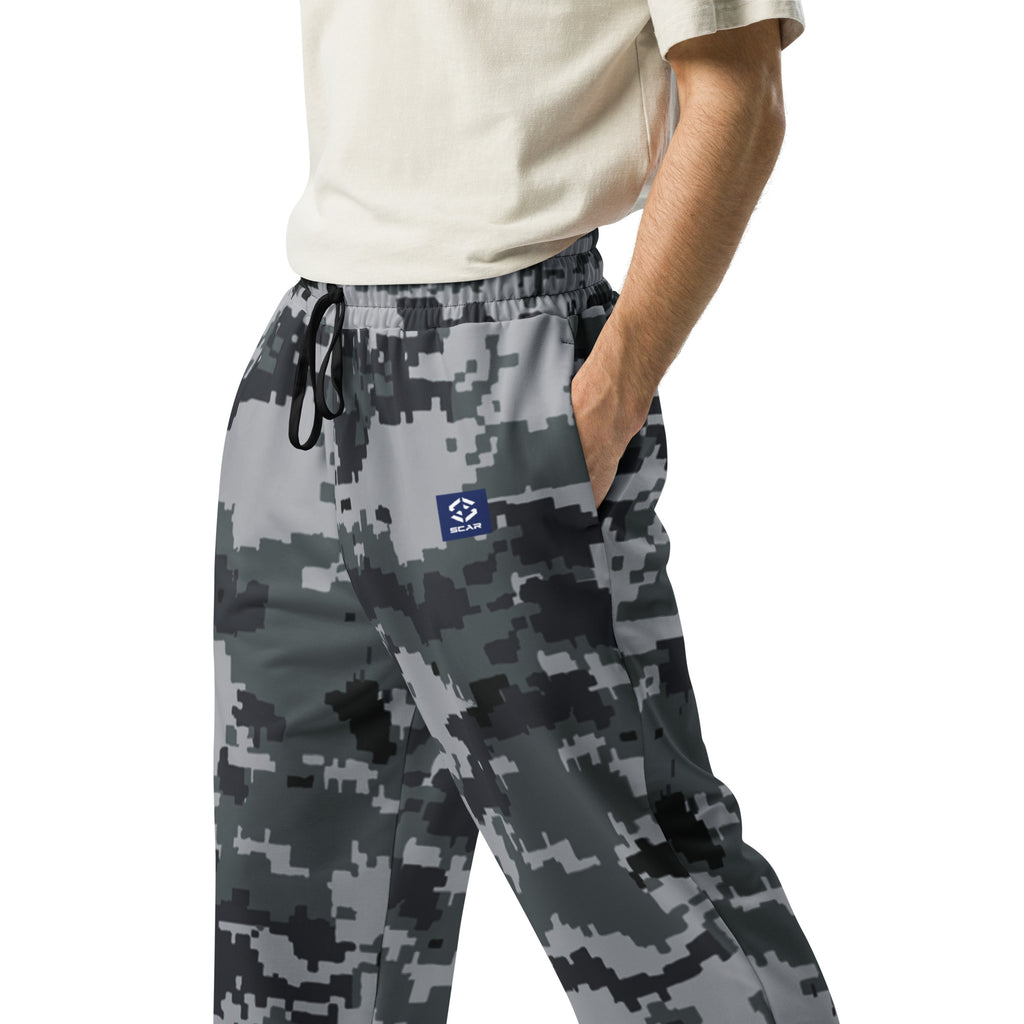 Detail of digital camo joggers: elastic waistband with black drawstring and logo patch