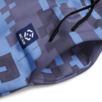 Close-up of digital camouflage joggers fabric with logo patch and drawcord