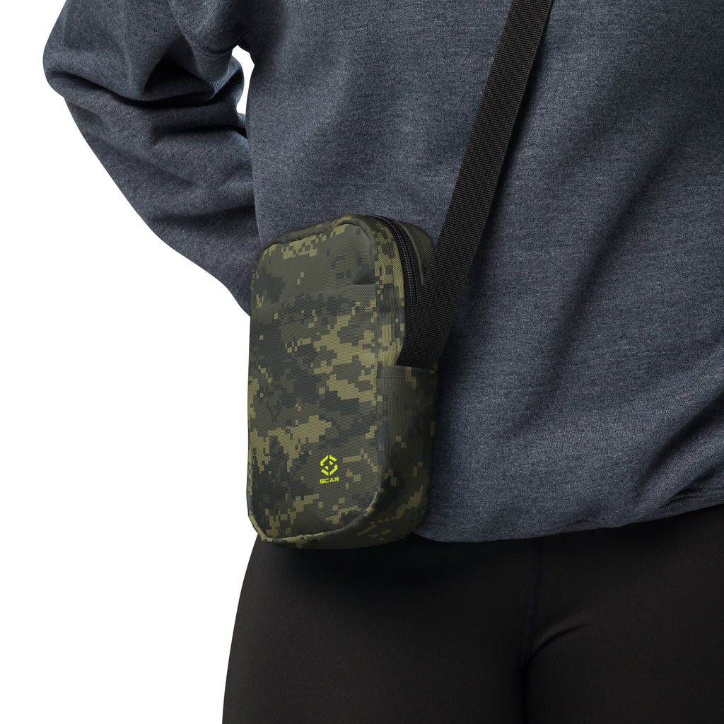 Digital camo crossbody bag on arm with black strap and small logo emblem