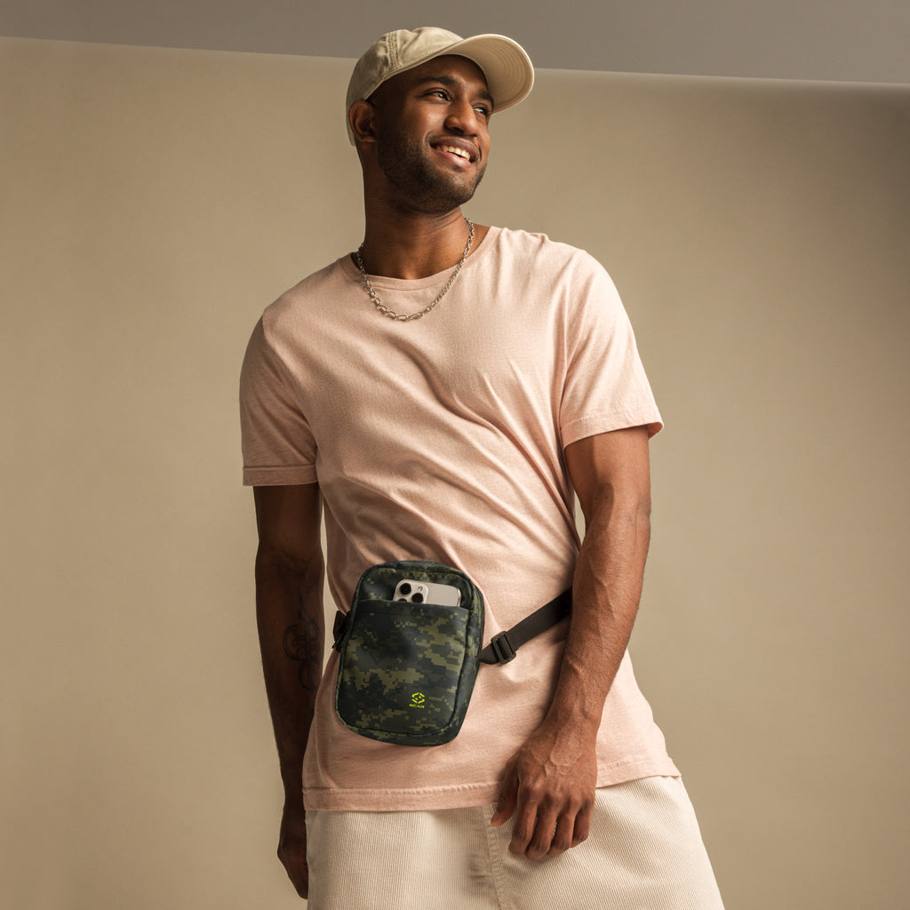 Digital camo crossbody bag worn on chest, black zipper and strap