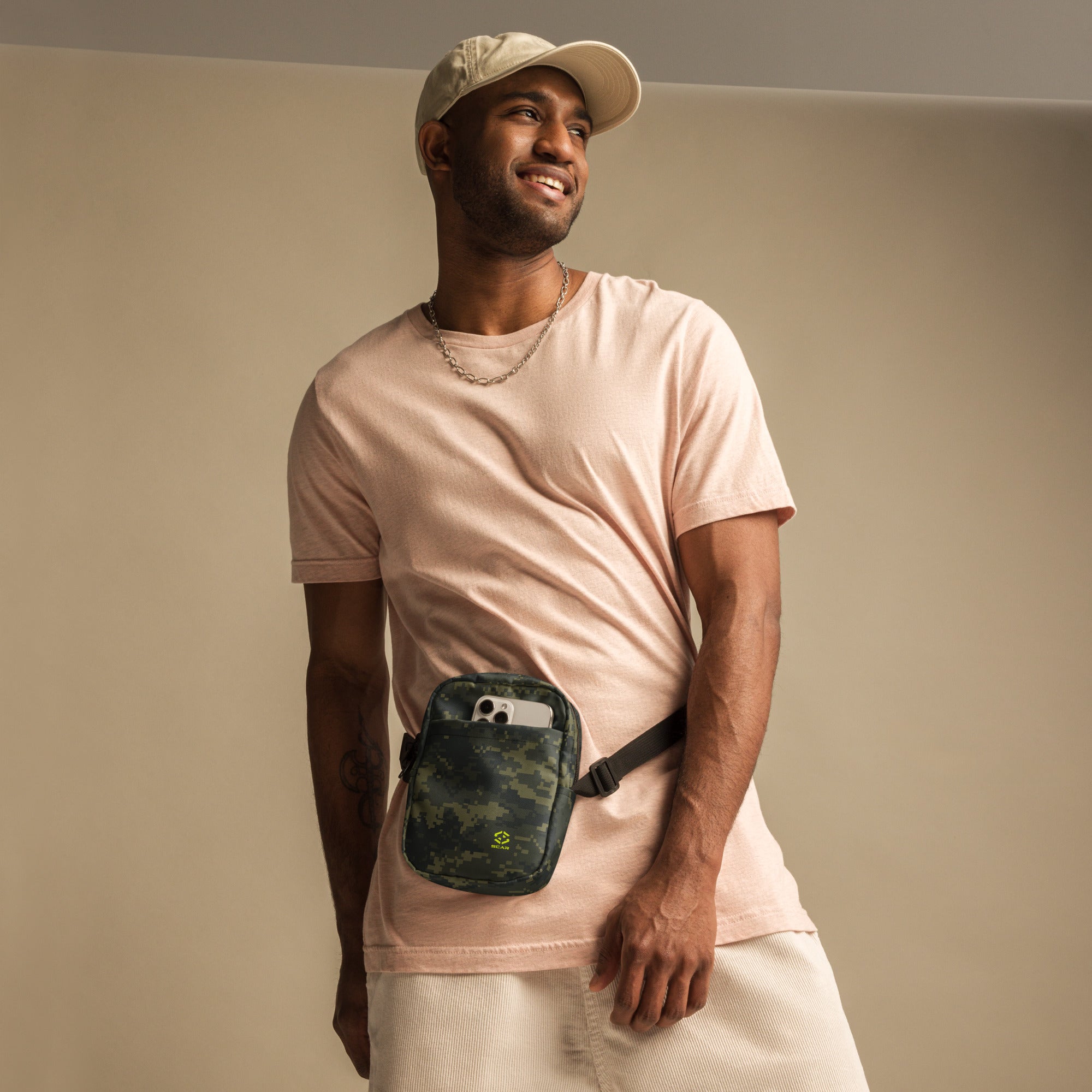 Digital camo crossbody bag worn on chest, black zipper and strap