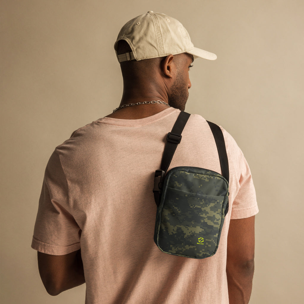 Small digital camo crossbody bag with black adjustable strap and front zipper pocket.