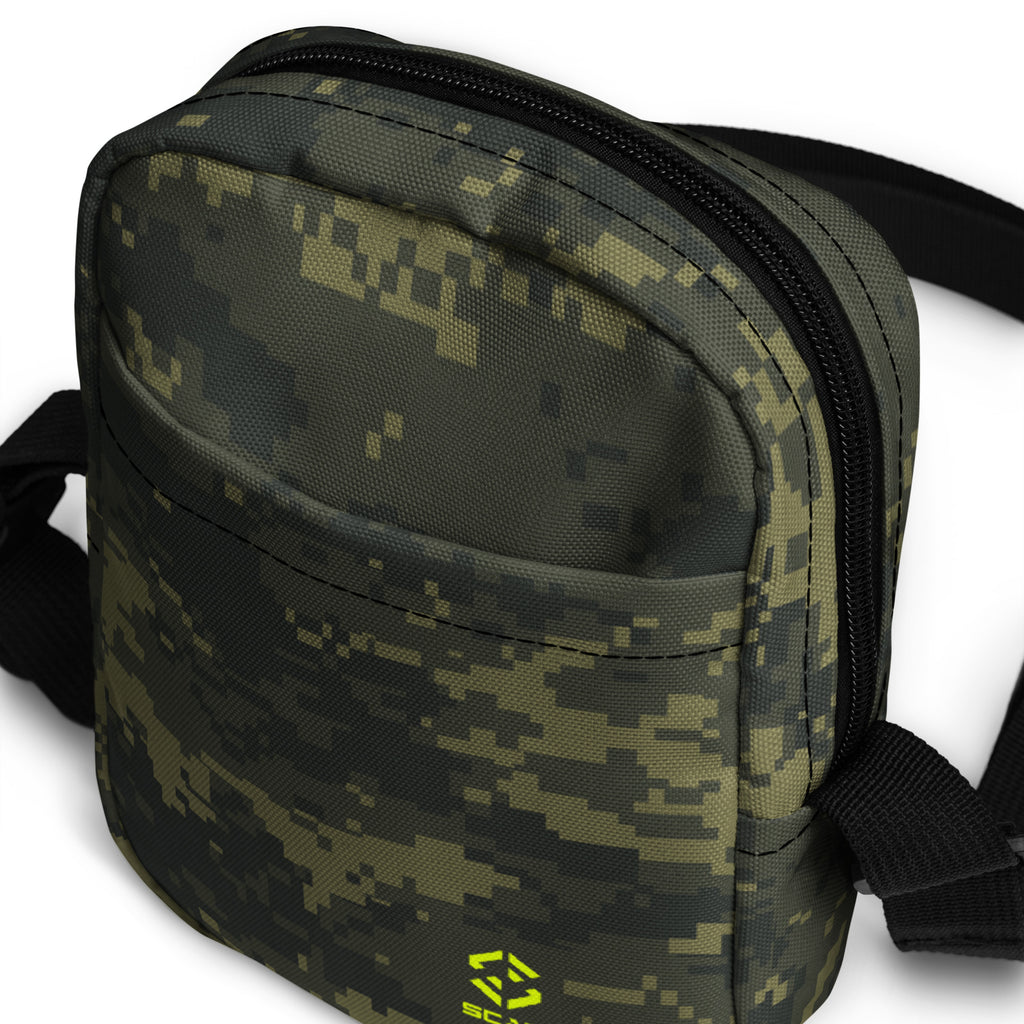 Digital camo crossbody bag close-up with curved front, dual zippers, and black trim.