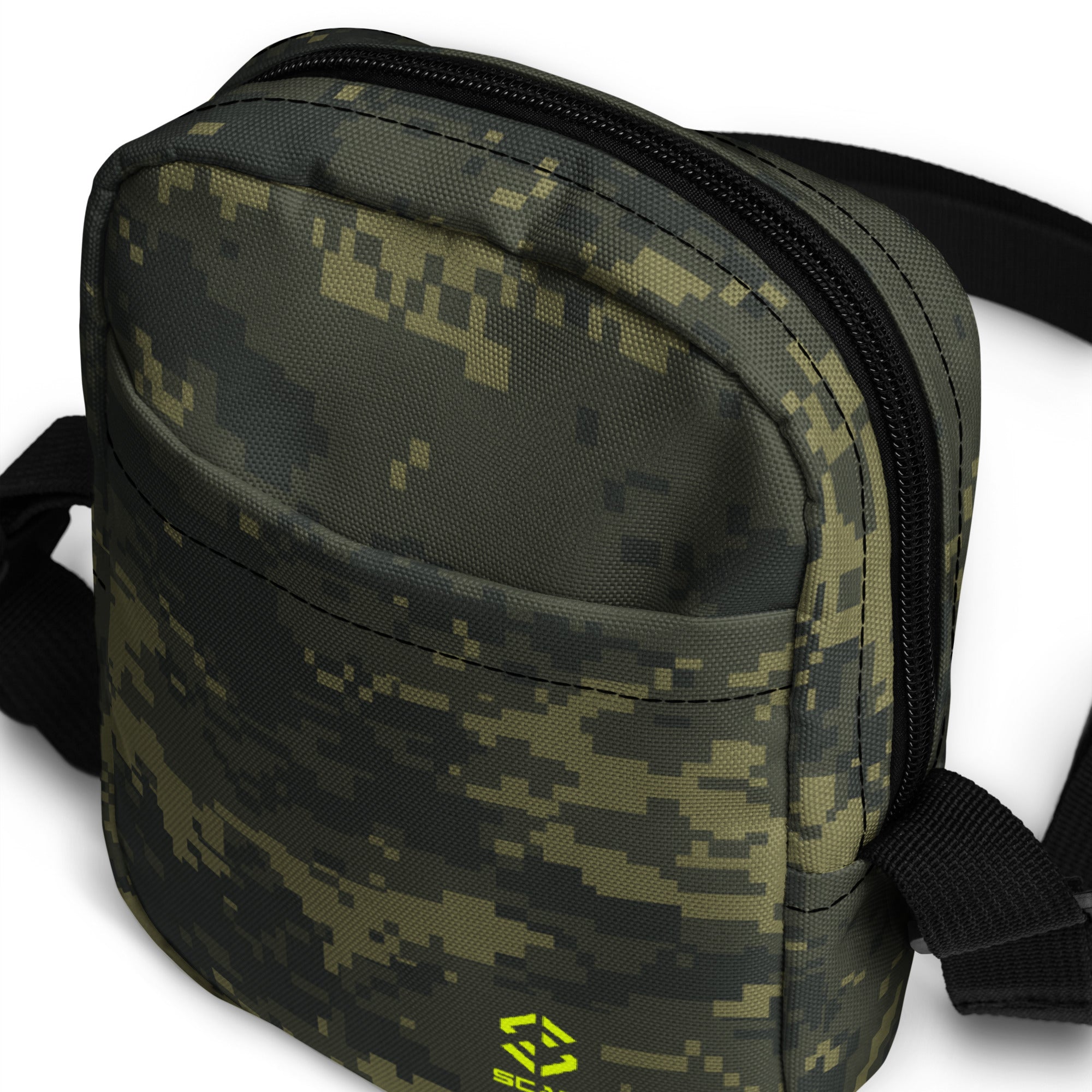 Digital camo crossbody bag close-up with curved front, dual zippers, and black trim.