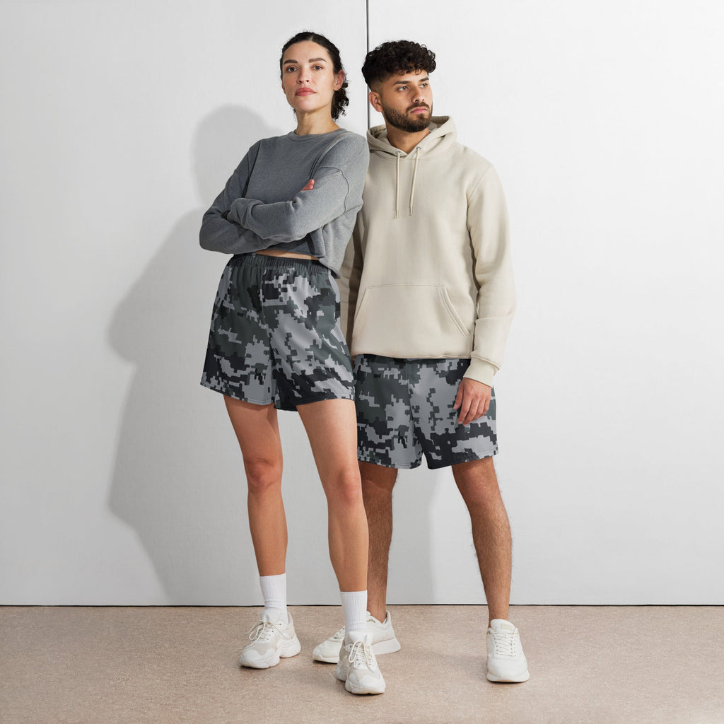 Digital camo athletic long shorts on model with elastic waistband and side pockets