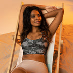 Longline sports bra with dark digital camo print, wide underband, racerback.