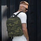 Camouflage backpack worn on shoulder, featuring a front pocket and adjustable straps.