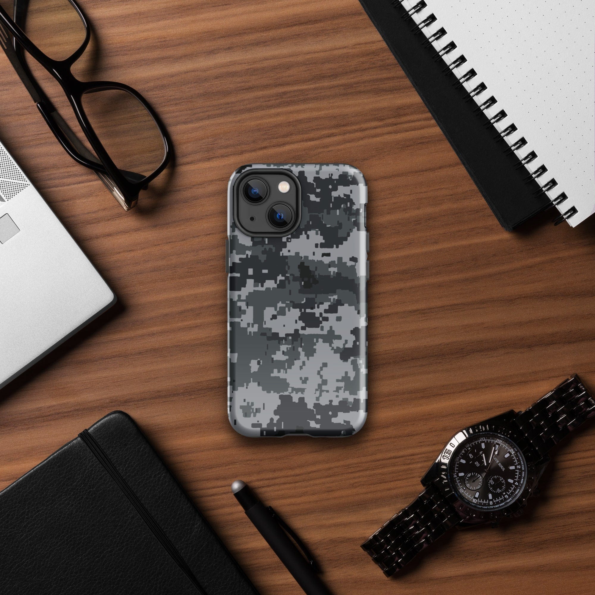 Gray digital camo iPhone case with raised camera edges on a rugged hard shell