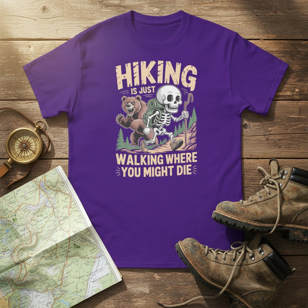 Purple graphic hiking T-shirt with skull-and-bear cartoon and slogan text.