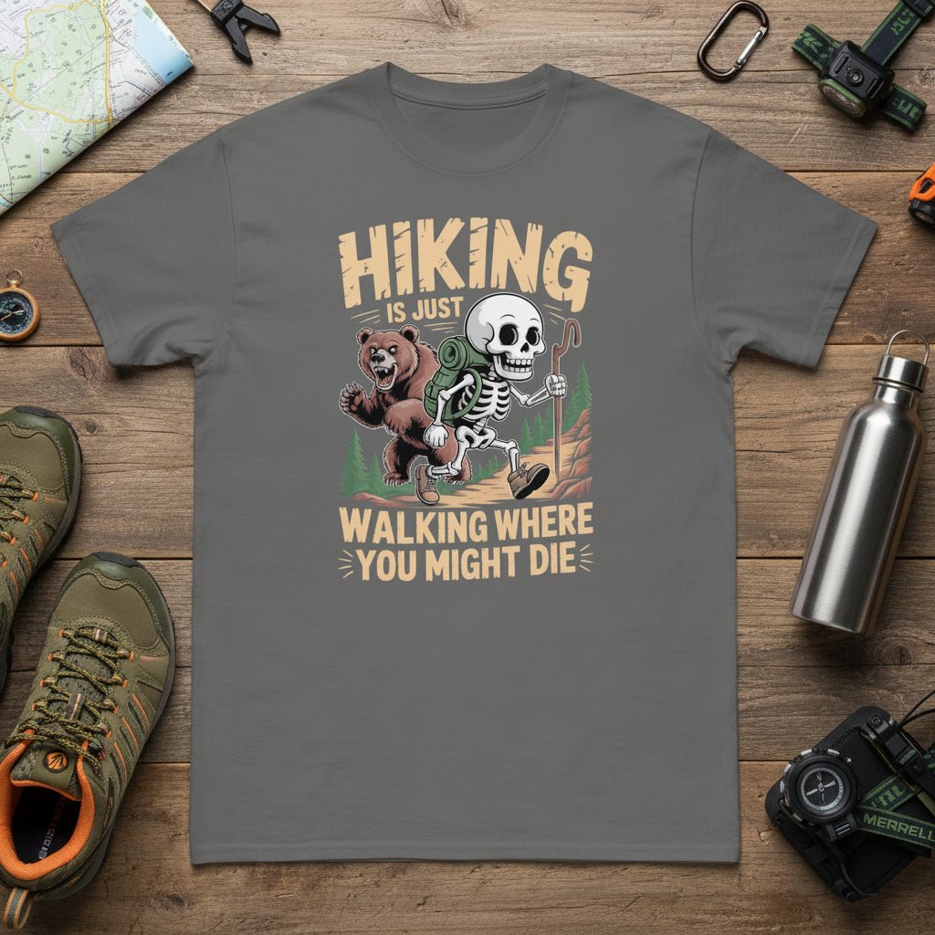 Dark gray graphic hiking T-shirt with skull-and-bear cartoon and slogan text.