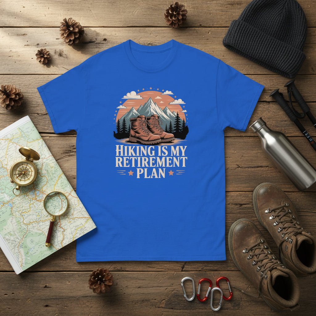 Blue hiking T-shirt with mountain-and-boots logo and “Hiking is my retirement plan” text.
