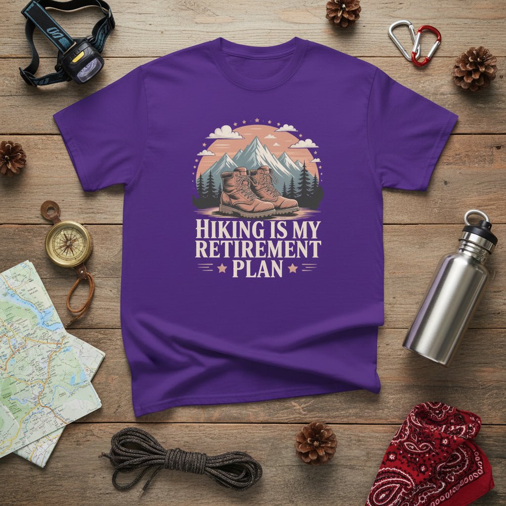 Purple hiking T-shirt with mountain-and-boots logo and “Hiking is my retirement plan” text.