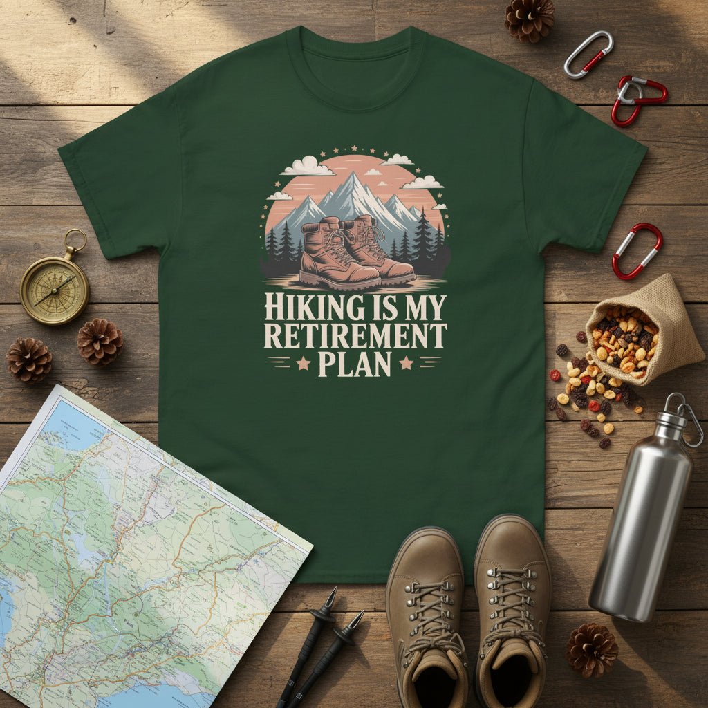 Forest green hiking T-shirt with mountain-and-boots logo and “Hiking is my retirement plan” text.