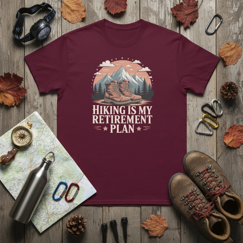Maroon hiking T-shirt with mountain-and-boots logo and “Hiking is my retirement plan” text.