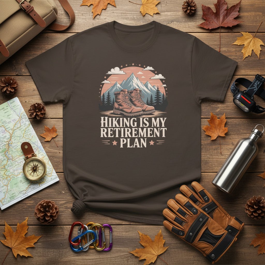 Dark brown hiking T-shirt with mountain-and-boots logo and “Hiking is my retirement plan” text.