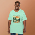 Mint green camping T-shirt on model with front graphic campsite and 'Pitch It' text