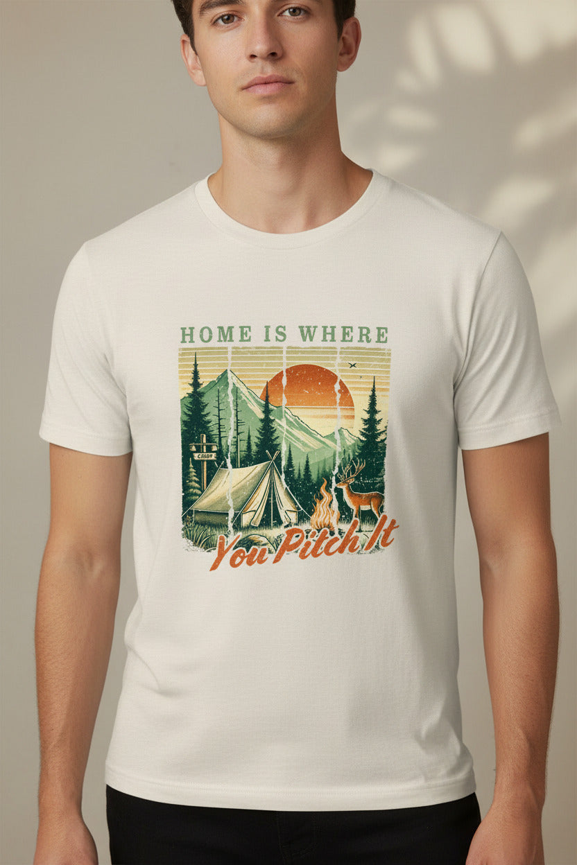 Light tan camping T-shirt with tent and pine trees graphic and “Home is where” text