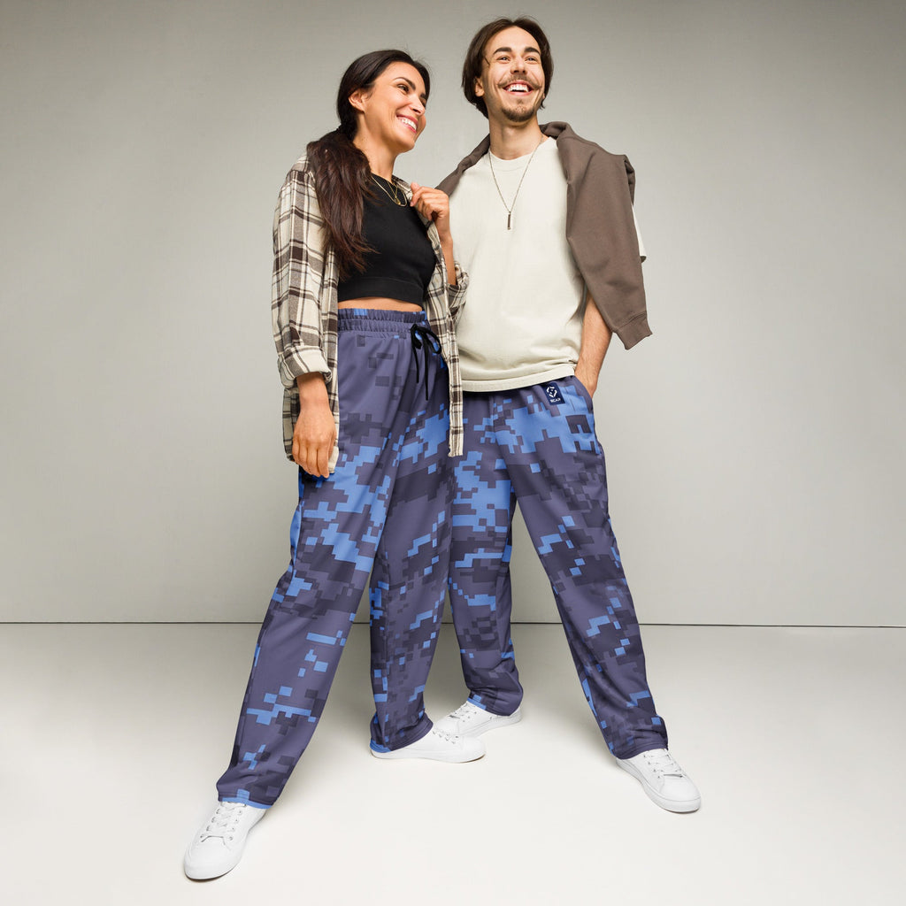 Digital camouflage wide-leg joggers on model, elastic waist and drawstring, relaxed fit
