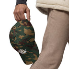 Green camo dad hat with white embroidered “Still Out There” logo on the front panel