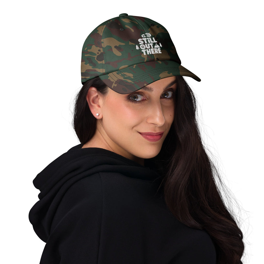 Dark camo embroidered dad hat worn by person, curved brim and adjustable fit