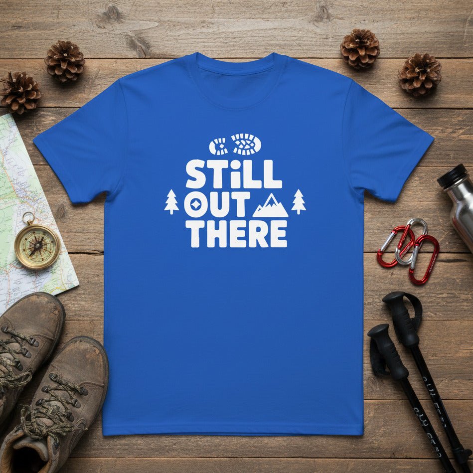 Hiking T-shirt, blue with white “Still Out There” logo and mountain/tree graphics