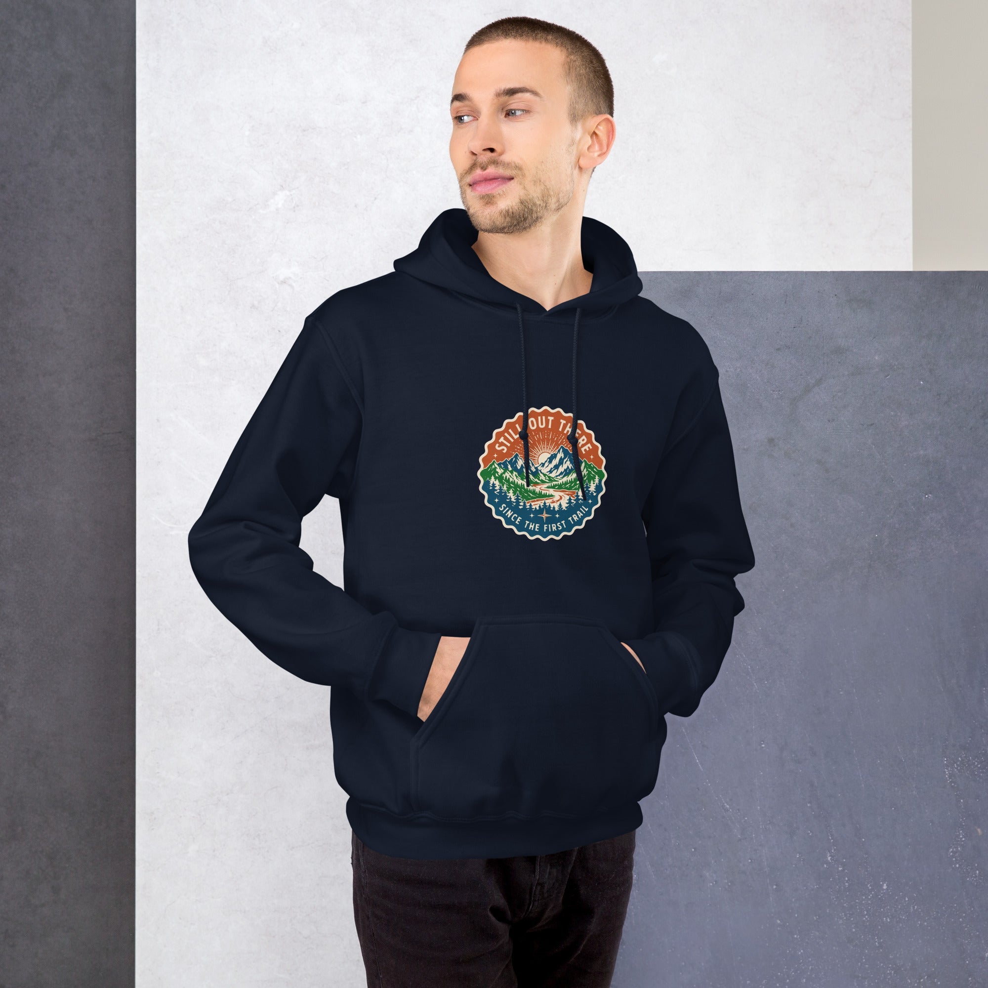 Navy mountain hoodie on model with front logo patch, drawstring hood, kangaroo pocket.