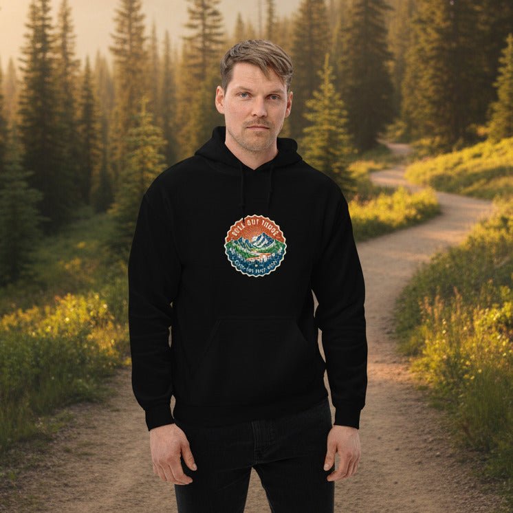 Black mountain hoodie on model with front logo patch, drawstring hood, kangaroo pocket.
