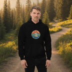 Black mountain hoodie on model with front logo patch, drawstring hood, kangaroo pocket.