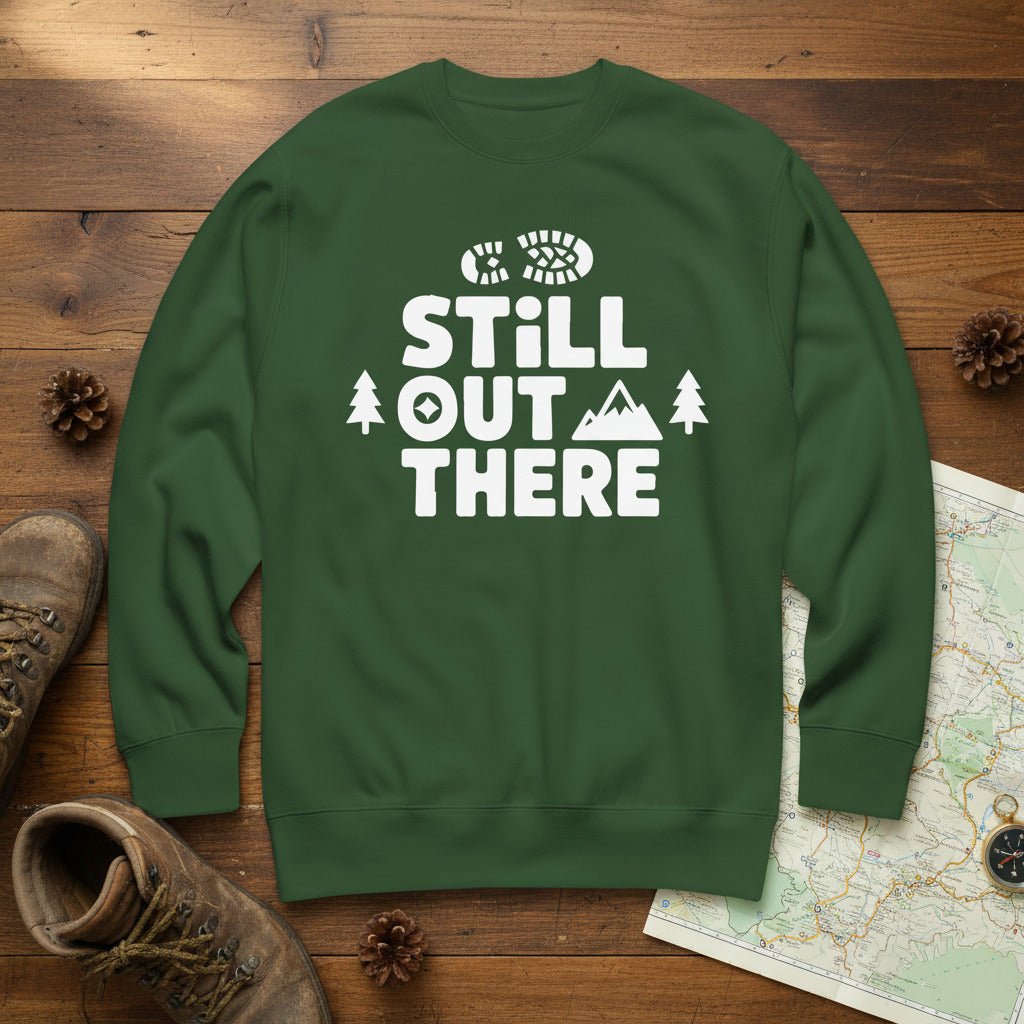Green hiking sweatshirt with crew neck and white “Still Out There” logo