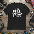 Black hiking T-shirt with white “STILL OUT THERE” logo and trees graphic