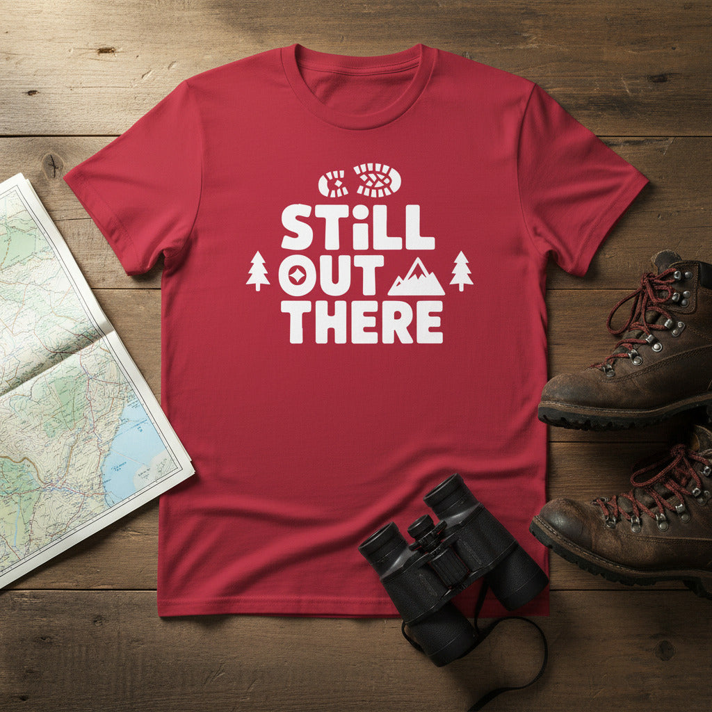 Red hiking T-shirt with white Still Out There logo and mountain/tree graphic.