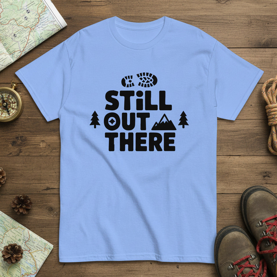Light blue crewneck hiking T-shirt with black “STILL OUT THERE” logo and trees