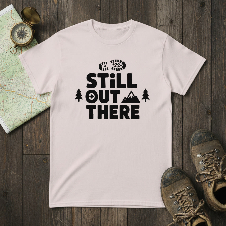 White crewneck hiking T-shirt with black “STILL OUT THERE” logo and pine trees
