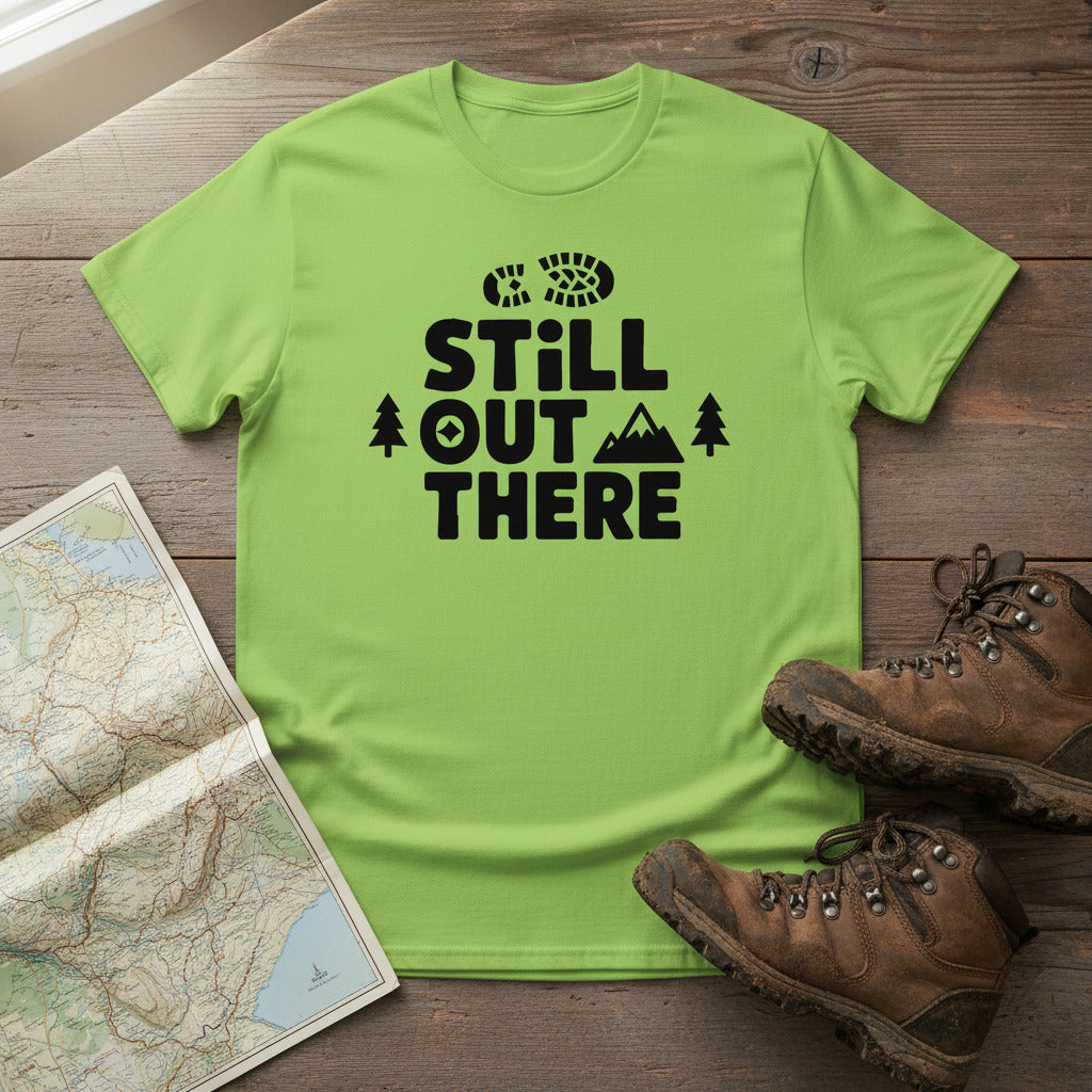 Lime green crewneck hiking T-shirt with black “STILL OUT THERE” logo and pines