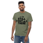 Olive green hiking T-shirt with black "Still Out There" logo graphic on the chest