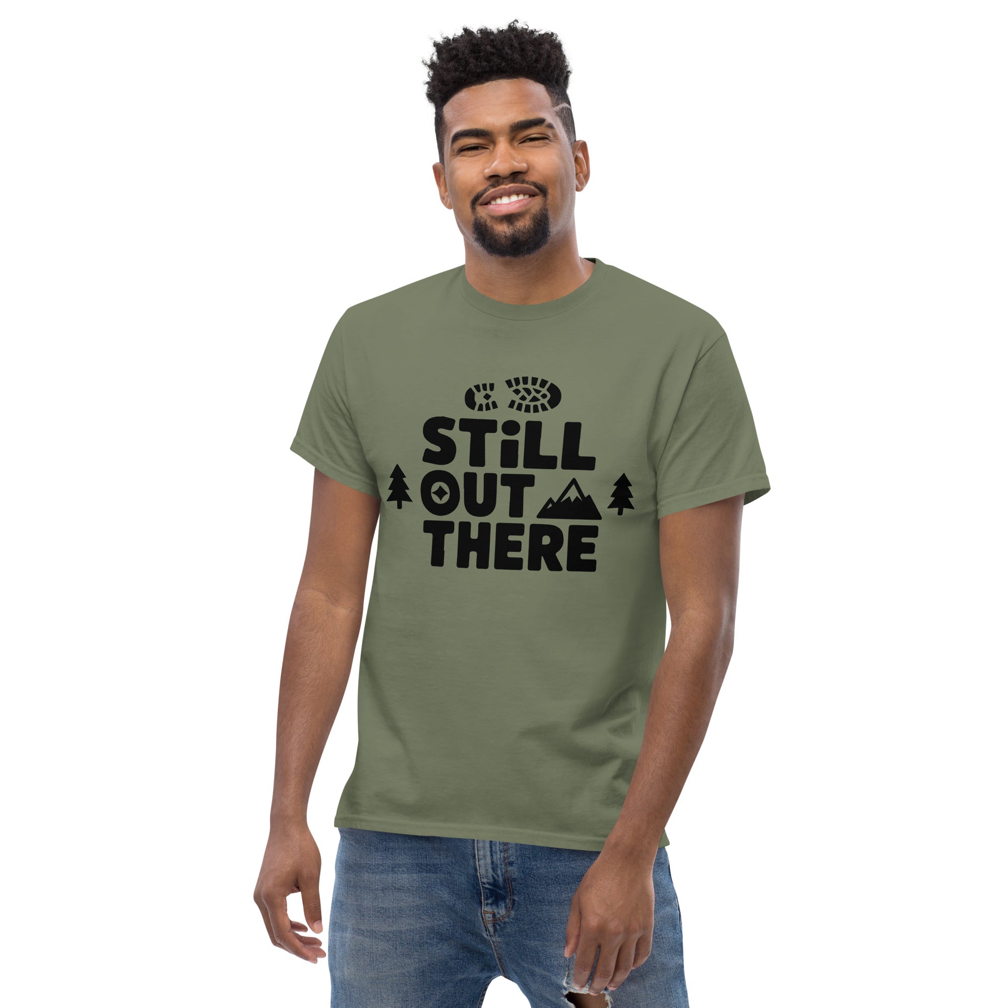 Olive green hiking T-shirt with black "Still Out There" logo graphic on the chest