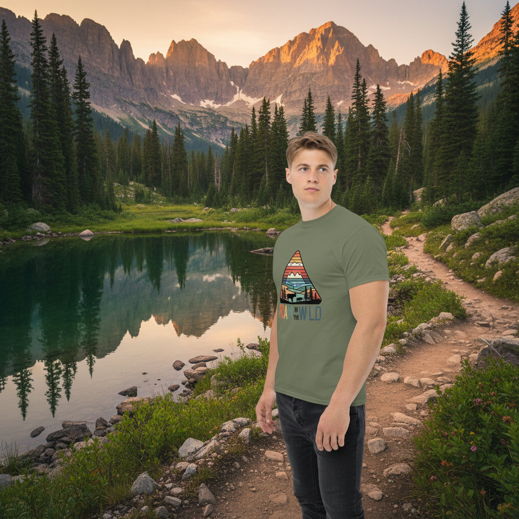 Olive green adventure T-shirt with triangle “Roam the Wild” landscape graphic
